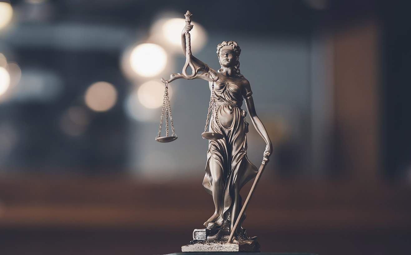 statue-of-lady-justice-on-desk-of-a-judge-or-lawye-2KASSBR.jpg